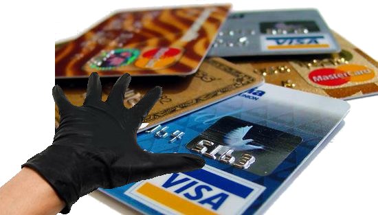 Gloved hand that is reaching for banking and credit info